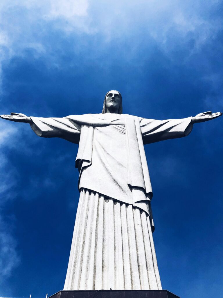 Majestic view of Christ the Redeemer statue in Rio de Janeiro, Brazil, under a clear blue sky.