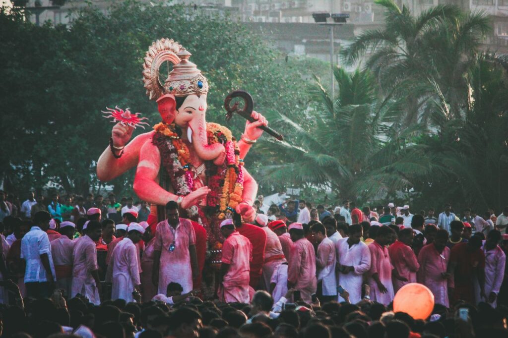 Colorful crowds celebrate Ganesh Chaturthi in Mumbai with a grand Ganesha statue.